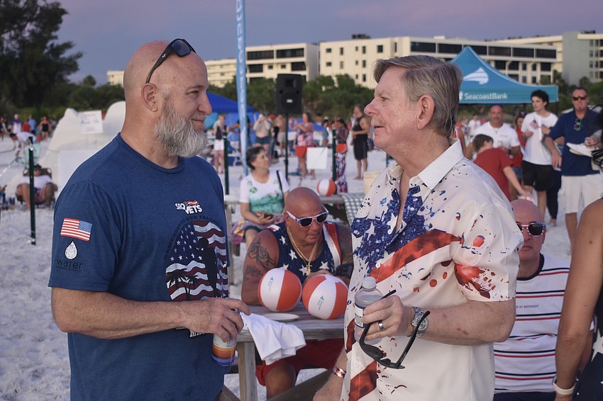 Mike Gatz talks with County Commissioner Mark Smith.