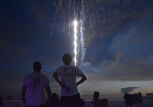 Eric Ribeiro and his son, Luke Ribeiro, 17; watch the fireworks from the VIP and sponsors area.