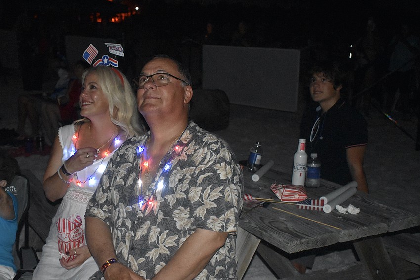 Yanet Cisnero, husband Dani Escalona and son Fabio Escalona, 14 watch the fireworks from the sponsors and VIP area.
