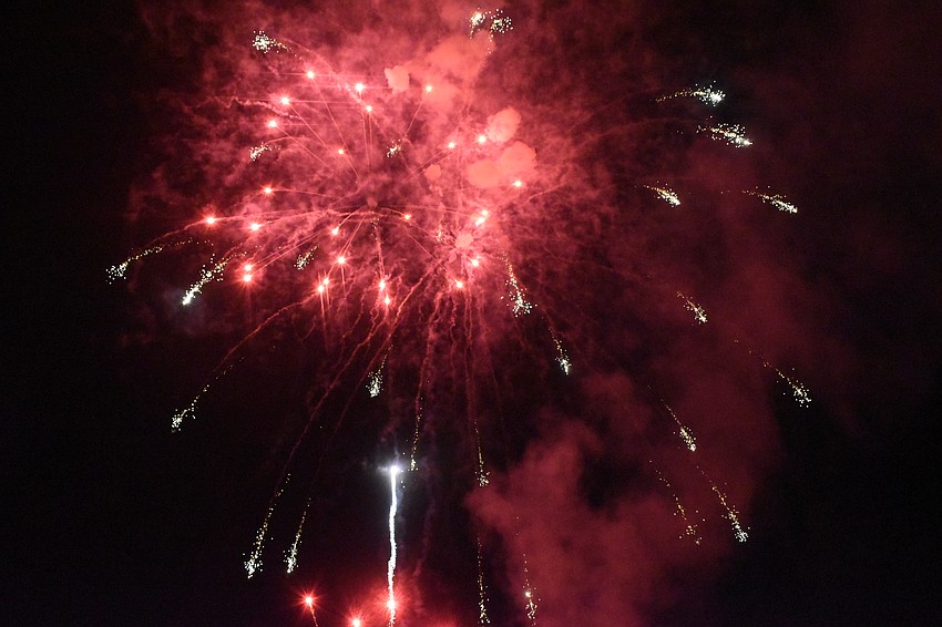 The rockets' red glare emerges over Siesta Key Beach.