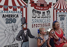 Lakewood Ranch's Harper Fraser, 7, Jack Fraser, 5, and their mom, Melissa Fraser, test out the Royally Cosmic photo booth at the Star-Spangled Spectacular at Waterside Place.