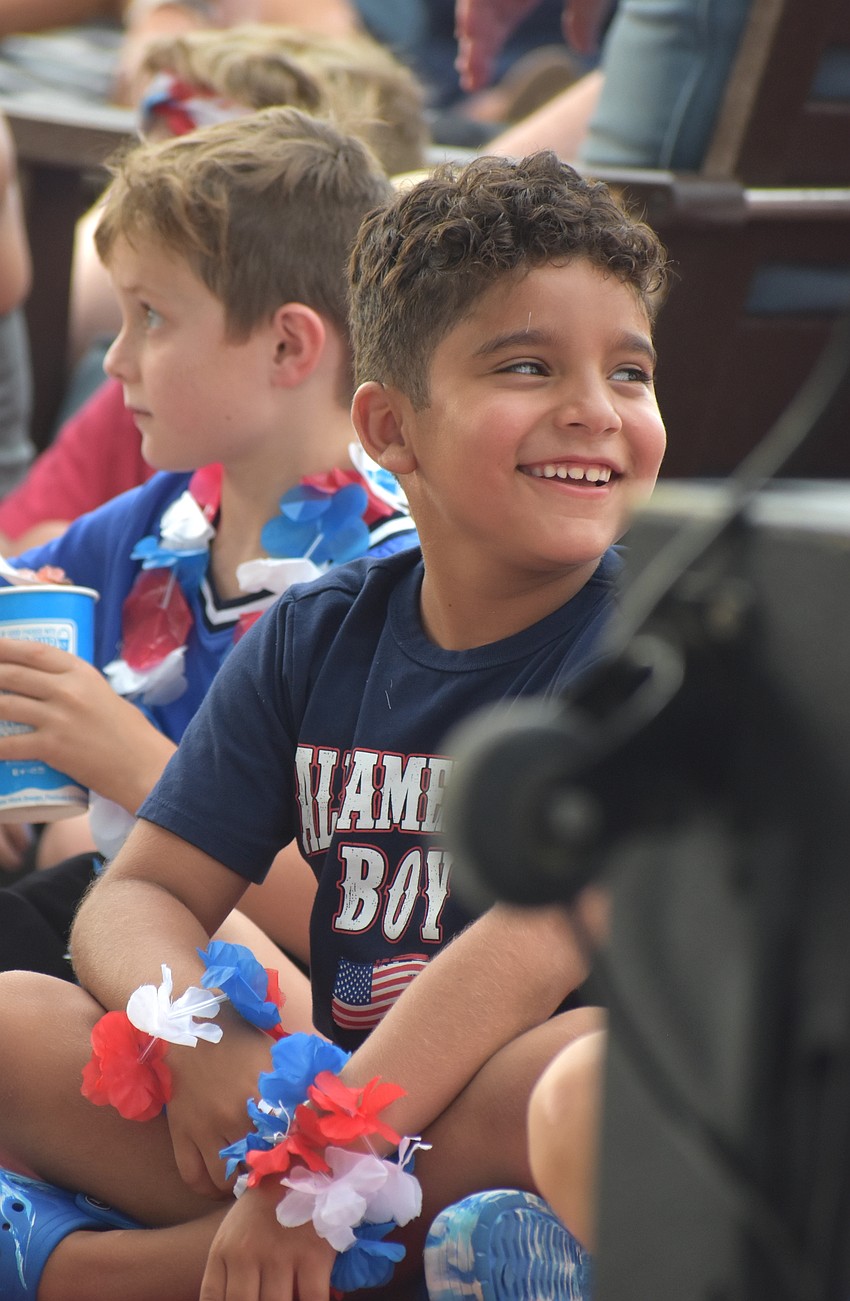 Parrish's Jordan Souza, 7, watches Noah Royak juggle at the Star-Spangled Spectacular at Waterside Place.