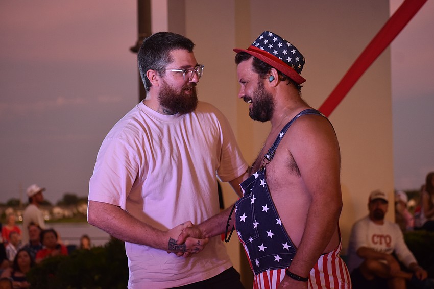 Aaron Sauer and Justin Marcotte greet each other moments after being picked from the audience to be part of the Circus Arts Conservatory performance during the Star-Spangled Spectacular at Waterside Place.