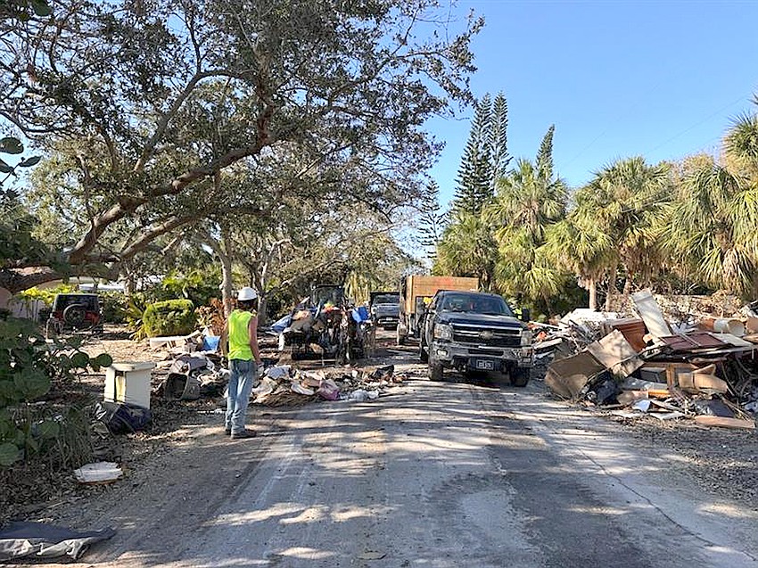 Debris removal along a Sarasota County street following back-to-back hurricanes in 2024. Debris removal along a Sarasota County street following back-to-back hurricanes in 2024.