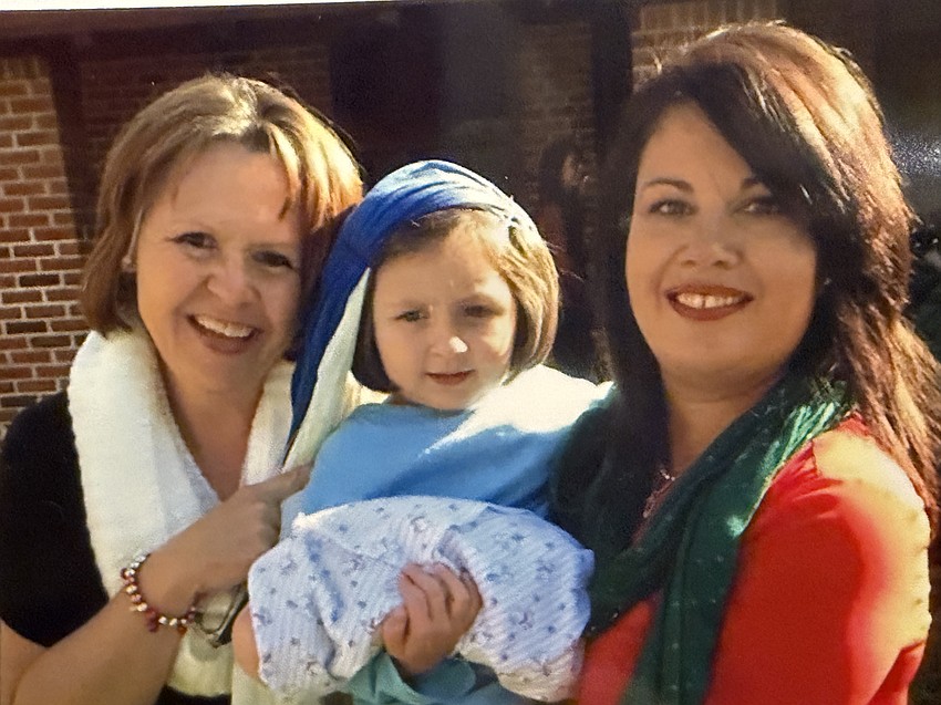 Wendy Davis, left, and Lily Frets, right, who are former directors of the Learning Center, always loved seeing the Christmas pageant with students such as Scarlett Bertsch, center, playing Mary and other roles.