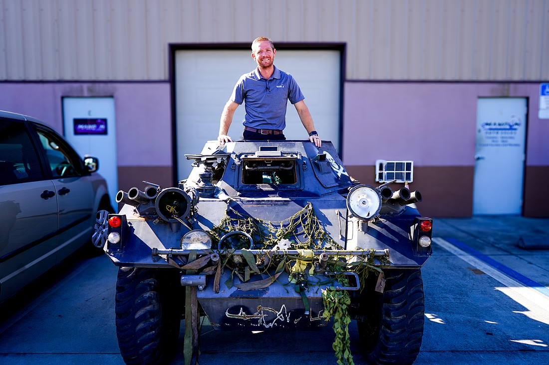 Michael Mangum stands inside of a 1959 Daimler Dingo Scout at Mangum Motorsports in Palm Coast. Photo by Rachel Mills