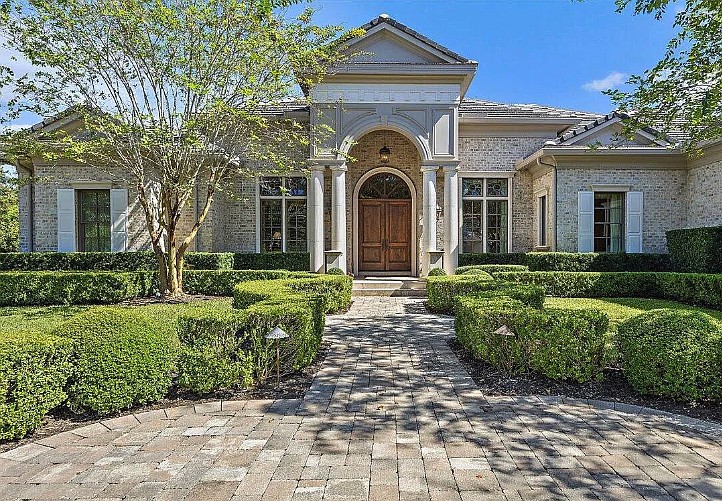 Pond oriented single-story home in Pablo Creek Reserve. Features five bedrooms, five full and one half-bathrooms, porches, guesthouse, an outdoor kitchen, a pool, circular driveway and three-car garage.