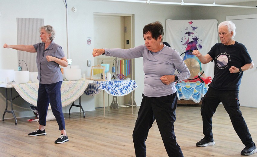 Tai chi students, including Fran Van Zandt, follow along with Reuben Fernandez's instructions at the Wednesday, July 8 class at The Paradise Center.