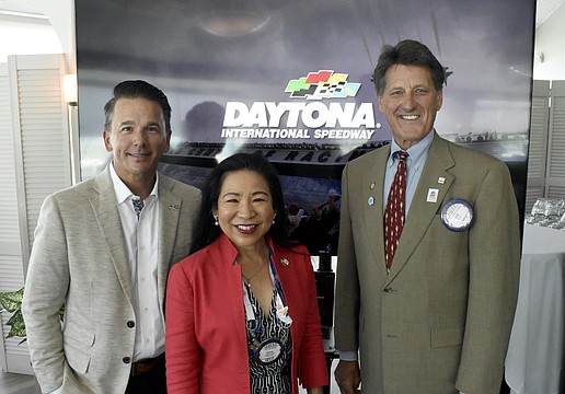 Frank Kelleher stands with former Rotary Club of Sarasota president Lee-En Chung and president Bob Stobaugh.