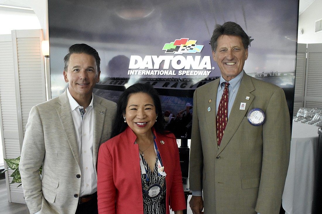 Frank Kelleher stands with former Rotary Club of Sarasota president Lee-En Chung and president Bob Stobaugh.