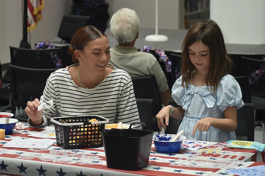 Courtney Robb and her daughter Quinn Robb-Nash, 6, work on an art project.