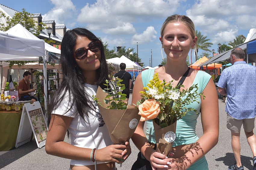 Lakewood Ranch's Luna Ahumada and Jordan Ventresca show off flowers from Posies at the Farmers' Market at Lakewood Ranch.