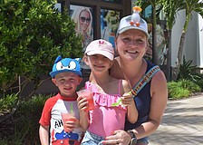 Boston's JJ Maguire, 4, Ariel Maguire, 6, and their mom, Kasha Grabowski, wear funky hats while enjoying treats from Jeremiah's Italian Ice at the Farmers' Market at Lakewood Ranch.