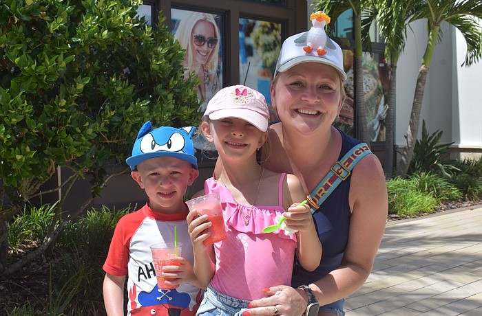 Boston's JJ Maguire, 4, Ariel Maguire, 6, and their mom, Kasha Grabowski, wear funky hats while enjoying treats from Jeremiah's Italian Ice at the Farmers' Market at Lakewood Ranch.