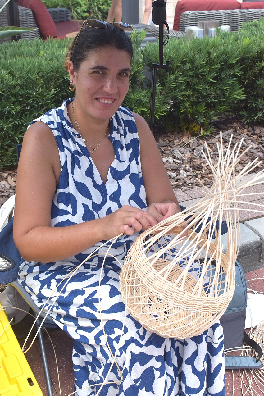 Dilek Koc, the owner of Myrattan Studio, demonstrates how to make a basket at the Farmers' Market at Lakewood Ranch.