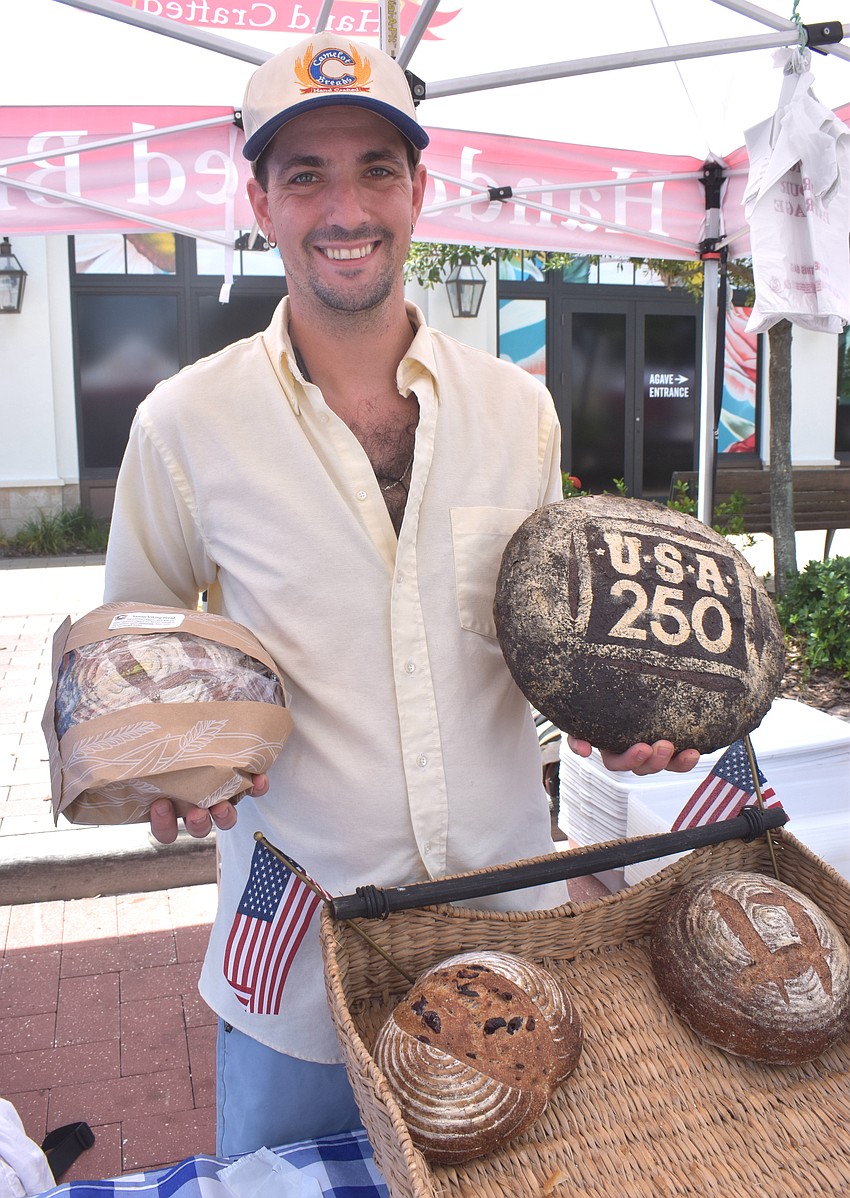 Bryce Toporowski of Camelot Breads keeps market goers informed of how the breads were made while also celebrating the nation's 250th birthday.