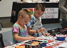 Alex Walker, 6, and Max Walker, 8, work on paintings at the America250 Celebration at Selby Library.