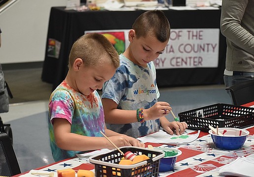Alex Walker, 6, and Max Walker, 8, work on paintings at the America250 Celebration at Selby Library.