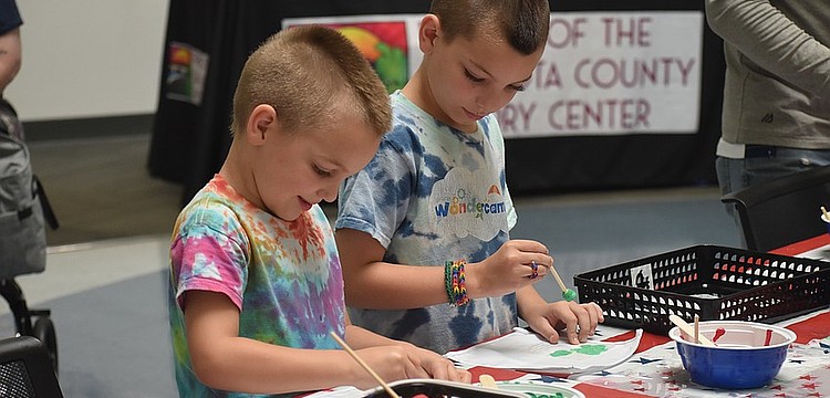 Alex Walker, 6, and Max Walker, 8, work on paintings at the America250 Celebration at Selby Library.