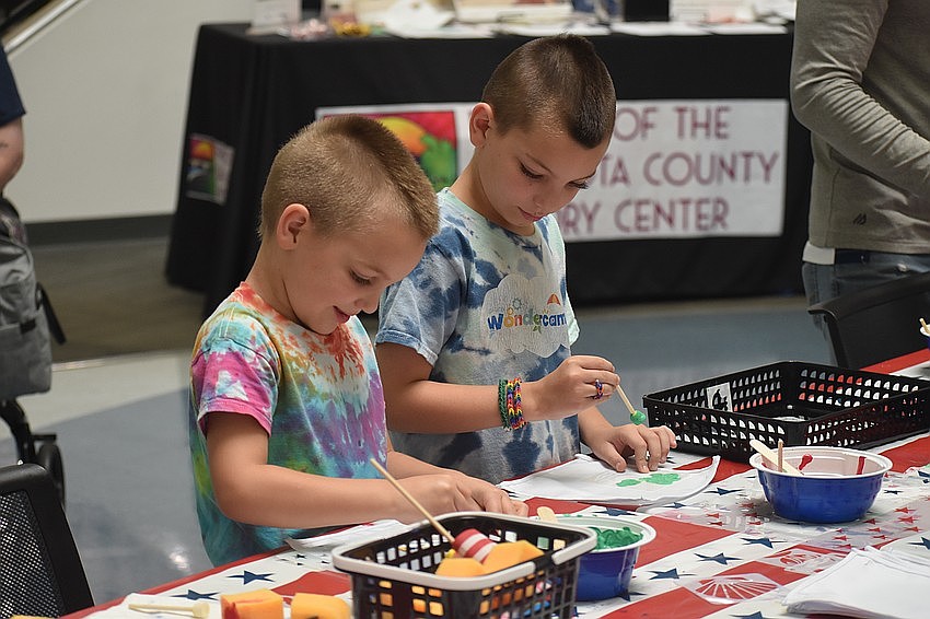 Alex Walker, 6, and Max Walker, 8, work on paintings at the America250 Celebration at Selby Library.