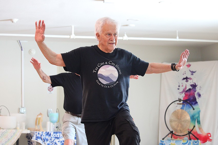 John Sackler, a longtime attendee of Reuben Fernandez's tai chi classes on Longboat Key, demonstrates his balance skills in a high-step exercise.