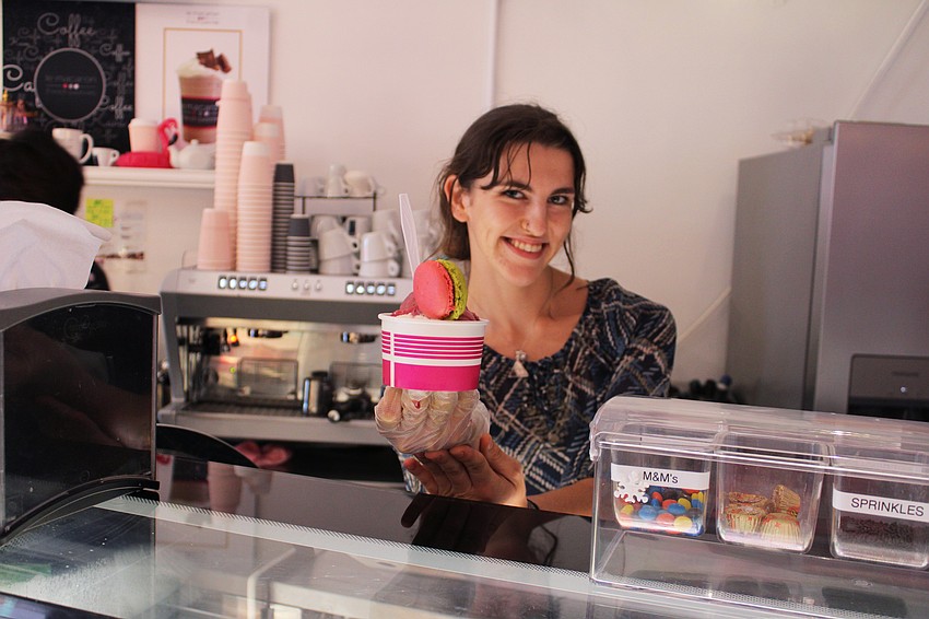 Kyla Balas tops a scoop of raspberry sorbet with the signature French cookie of Le Macaron French Pastries on St. Armands Circle. She said either the sorbet or the gelato can be blended for a refreshing drink to enjoy while shopping around the Circle.