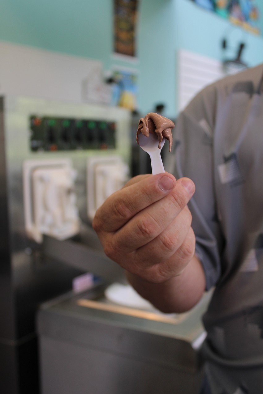 Wolfe Shaw shows off the texture of the freshly churned chocolate frozen custard at the new M & W Sweet Spot.