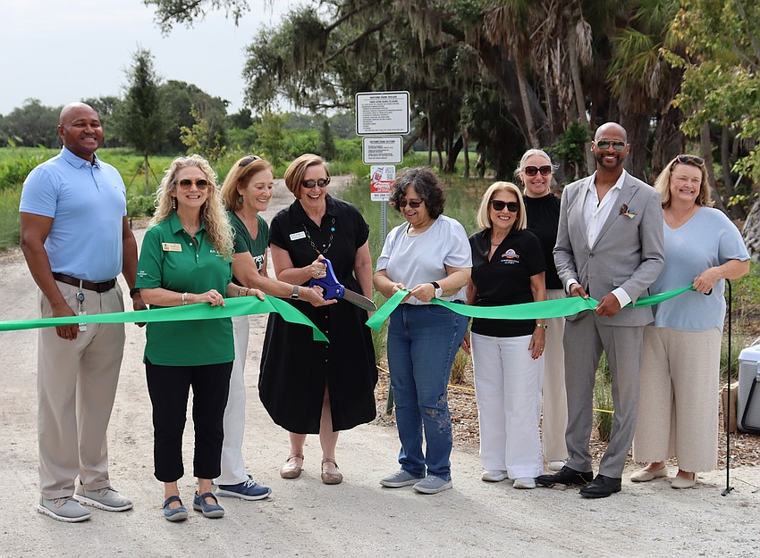 The Bobby Jones Nature Park ribbon-cutting included Sarasota Parks and Recreation Director Jerry Fogle, city commissioners Jen Ahearn-Koch and Kathy Kelley Ohlrich, Big Waters Land Trust President Christine Johnson, Mayor Debbie Trice, Commissioner Liz Alpert, Deputy City Manager Jennifer Jorgensen, Commissioner Kyle Battie, and City Manager Karie Friling. The Bobby Jones Nature Park ribbon-cutting included Sarasota Parks and Recreation Director Jerry Fogle, city commissioners Jen Ahearn-Koch and Kathy Kelley Ohlrich, Big Waters Land Trust President Christine Johnson, Mayor Debbie Trice, Commissioner Liz Alpert, Deputy City Manager Jennifer Jorgensen, Commissioner Kyle Battie, and City Manager Karie Friling.