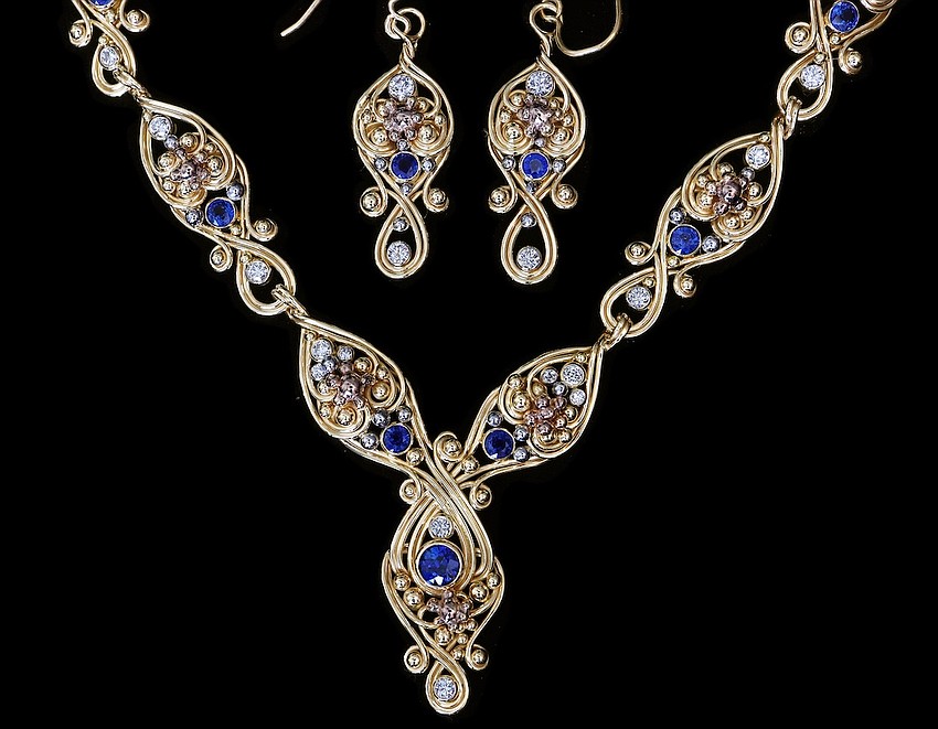 This necklace and earrings feature Todd Alan's swirl design.