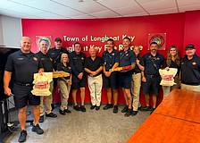 Alexander Fine (center) presented first responders from Longboat Key Fire Rescue with a pizza lunch last week for their efforts.