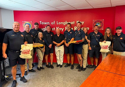 Alexander Fine (center) presented first responders from Longboat Key Fire Rescue with a pizza lunch last week for their efforts.