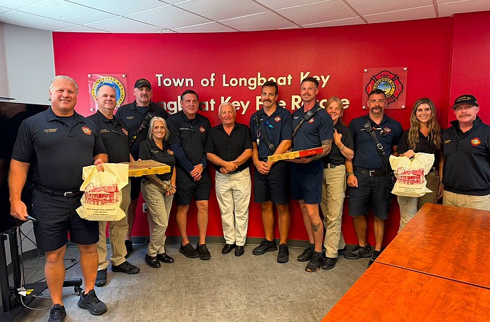 Alexander Fine (center) presented first responders from Longboat Key Fire Rescue with a pizza lunch last week for their efforts.