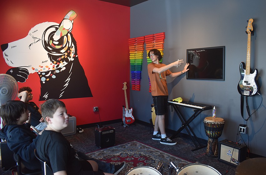 Bass players Mason Garcia, Zachary Stephenson and Mason Sessions learn from Chase Devore, who joined School of Rock in 2024, in the bass breakout session.