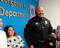 From left to right: Avery Mathis, Charlie Mathis, Michael Mathis and Jessica Mathis grin at a badge pinning ceremony where Michael Mathis was promoted to sergeant of the Longboat Key Police Department.