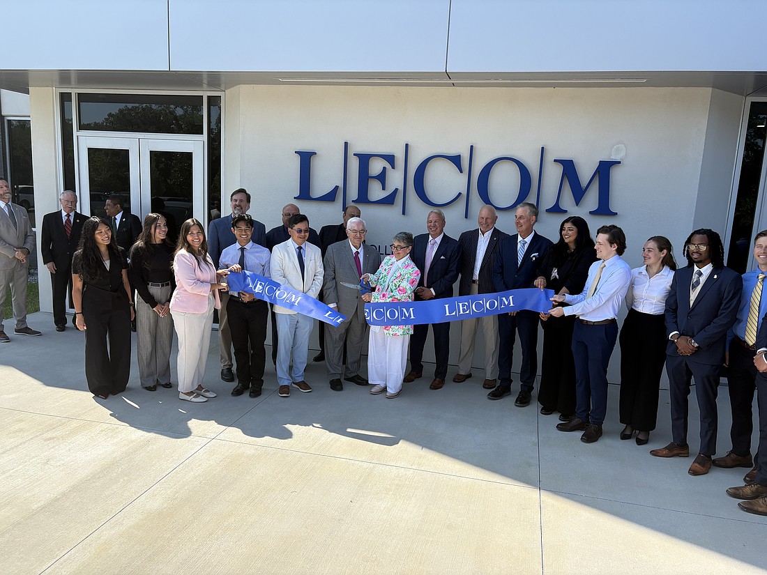 LECOM students and officials cut the ribbon in front of the school’s new Jacksonville campus.