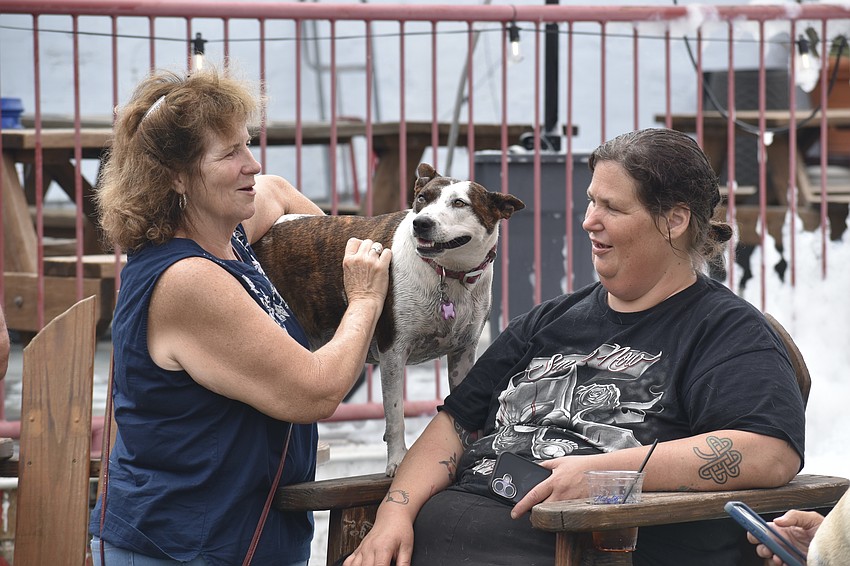 Alice Conklin talks with her friend Crystal Petersen and her dog Bean.