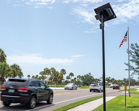 A Flock camera takes pictures of vehicles that drive on Gulf of Mexico Drive on Longboat Key.