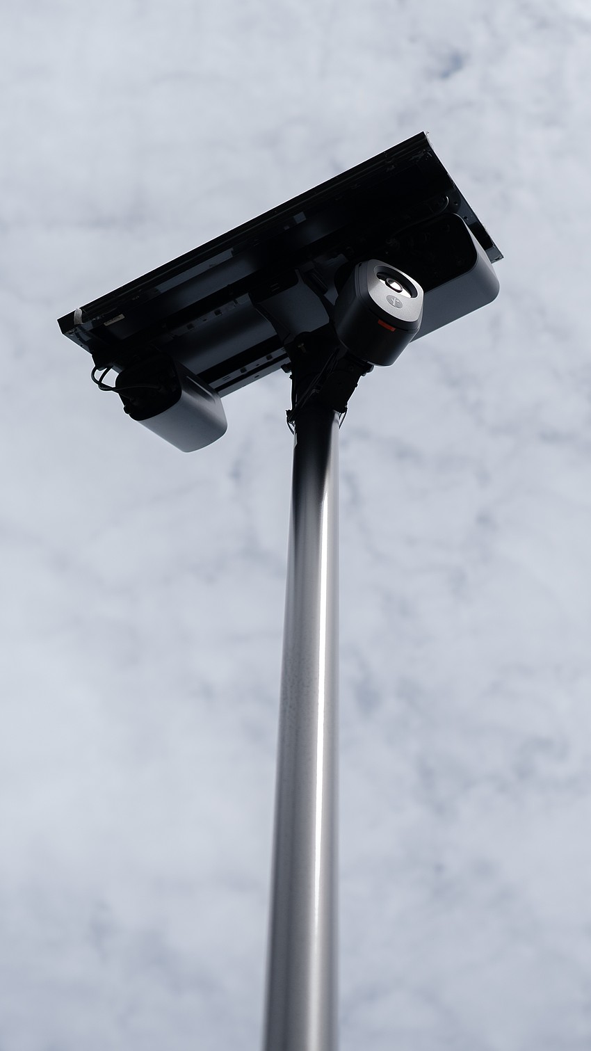 Flock camera poles are about 12 feet tall. The affixed cameras snap photos of every passing vehicle and note the license plate numbers and distinct characteristics like bumper stickers or vehicle damage. Flock camera poles are about 12 feet tall. The affixed cameras snap photos of every passing vehicle and note the license plate numbers and distinct characteristics like bumper stickers or vehicle damage.