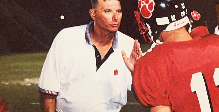 Bob Bowling (left) chews out his son, Matt Bowling (right), while coaching football at Palmetto High. Before Braden River, he worked at Palmetto from 1993-2004.