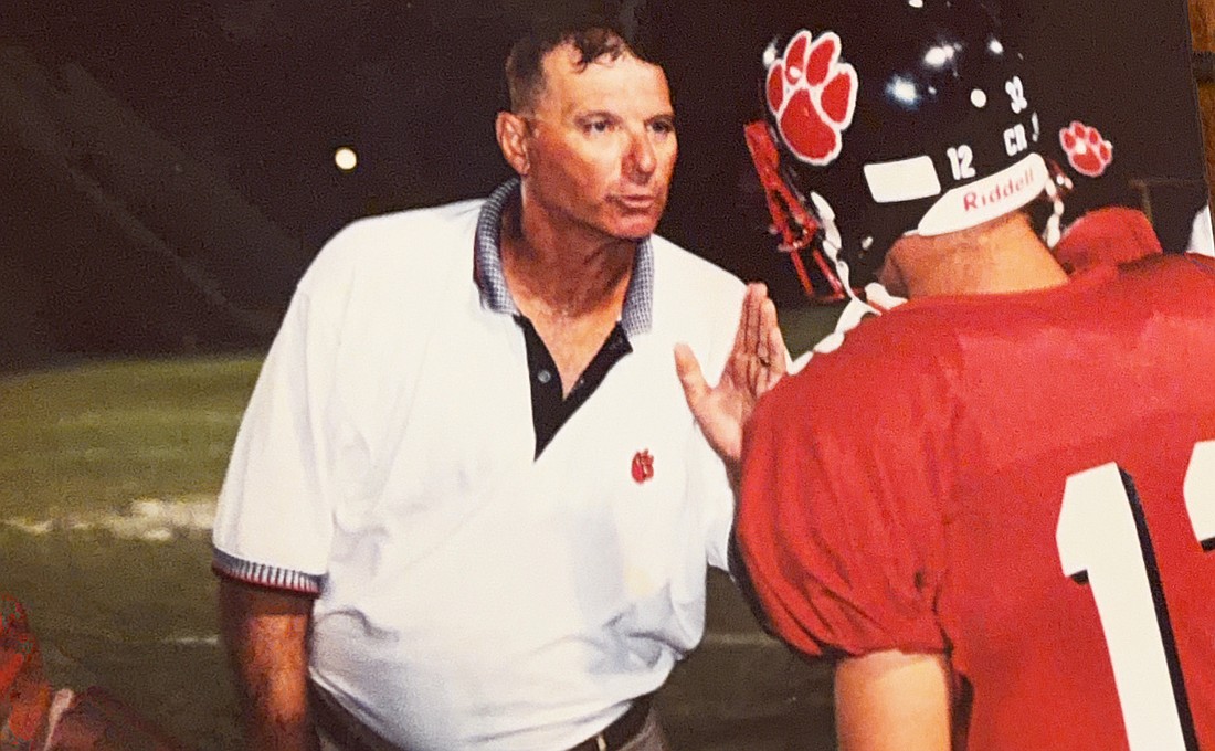 Bob Bowling (left) chews out his son, Matt Bowling (right), while coaching football at Palmetto High. Before Braden River, he worked at Palmetto from 1993-2004.
