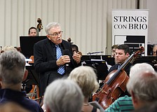 Maestro Kenneth Bowermeister, conductor of Strings Con Brio, welcomes a full house to the orchestra's first performance on Longboat Key on July 16 at Temple Beth Israel.