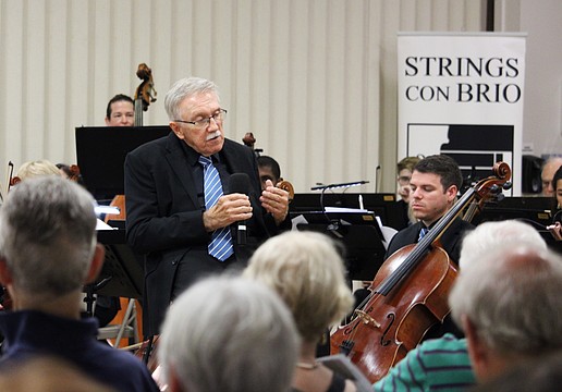 Maestro Kenneth Bowermeister, conductor of Strings Con Brio, welcomes a full house to the orchestra's first performance on Longboat Key on July 16 at Temple Beth Israel.