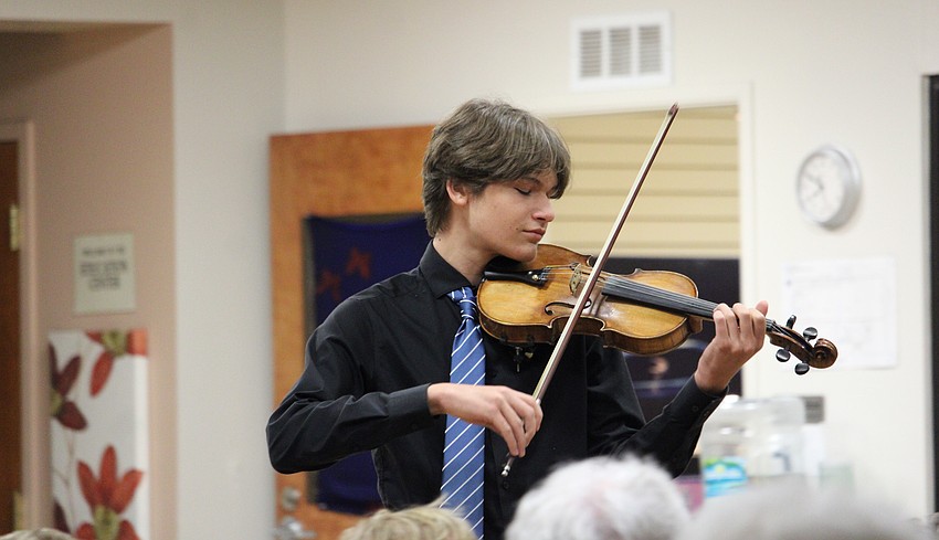 Andrii Padkovskyi steps into the crowd while playing the violin solo opening from 