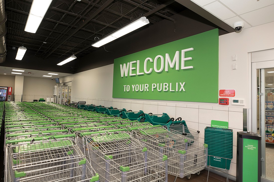 Publix shopping carts lined up in lobby with new Welcome to Publix sign.