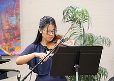 Danae Tran plays the violin for Longboat Island Chapel attendees of the July 19 morning service before she and fellow scholarship recipient Michelle McLeod move to greet guests at the award reception.