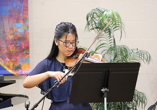 Danae Tran plays the violin for Longboat Island Chapel attendees of the July 19 morning service before she and fellow scholarship recipient Michelle McLeod move to greet guests at the award reception.