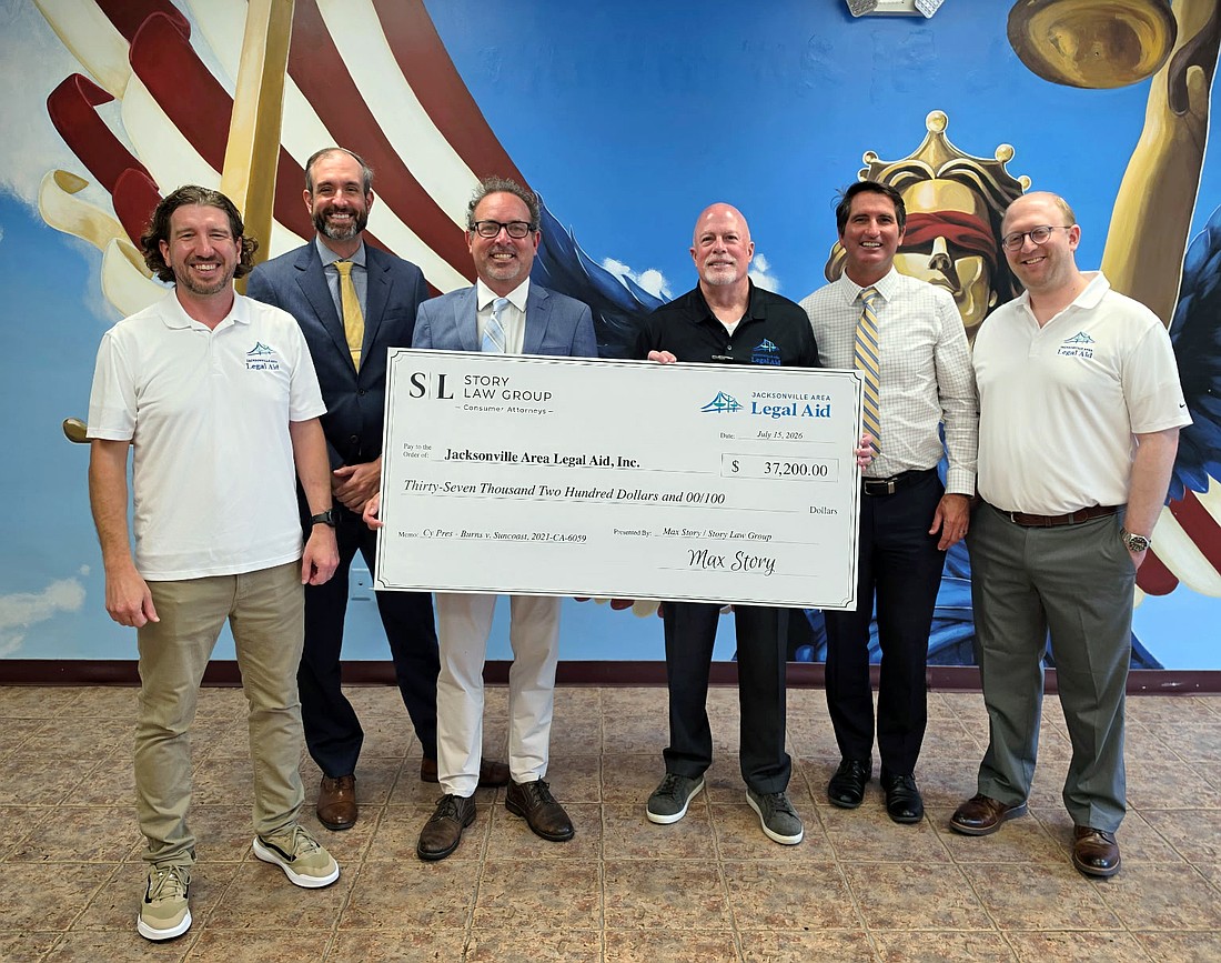 From left: Adam Thoresen, division chief of Jacksonville Area Legal Aid’s Consumer Advocacy and Litigation Unit; JALA board member David Johnston; attorney Max Story of Story Law Group; JALA President and CEO Jim Kowalski; JALA board member James Cummings; and JALA board member Andrew Underkofler.