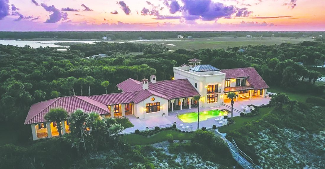 Oceanfront two-story home features five bedrooms, four full and one half-bathrooms, library, wine cellar, pantry, guest suite, balcony, patio, porches, pool, three-car garage and dune walkover.