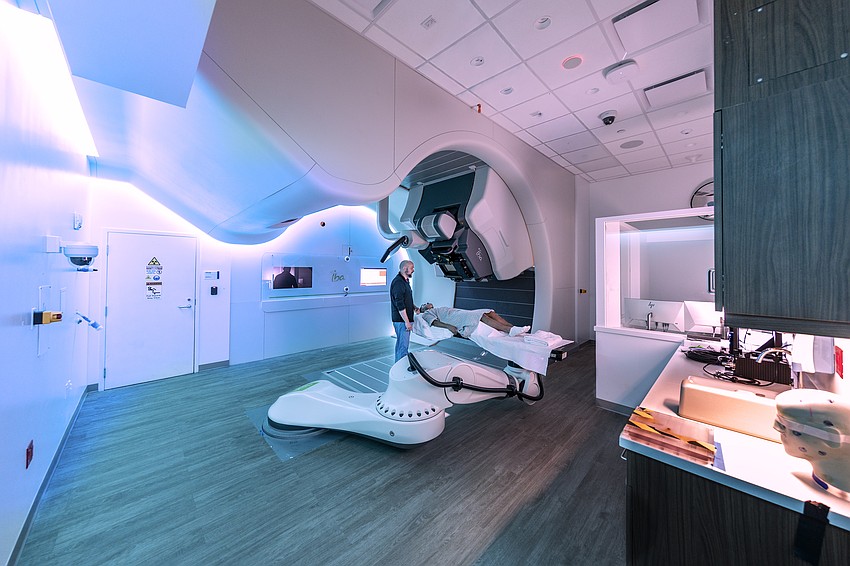 Moffitt Cancer Center staff demonstrate how a patient is positioned on the treatment platform before a proton therapy session using the ProteusOne system at the Richard M. Schulze Family Foundation Proton Center.