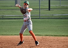 Henry Wainscott eyes first base with his throw during an around-the-horn drill at July 21 practice. He was one of 12 players who made up the 11U All-Stars — a team which finished 7-1 this summer.
